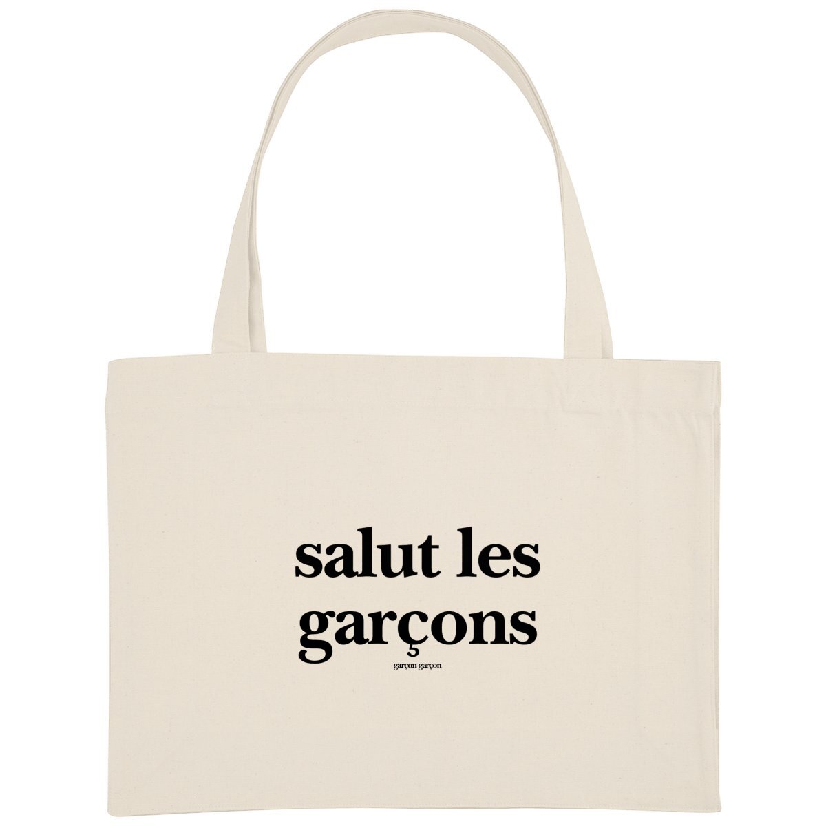 salut les garçons totebag. An eco-friendly cream-colored tote bag featuring the bold statement 'salut les garçons' in black typography, with the brand name 'garçon garçon' subtly placed underneath. A modern accessory that carries more than just your essentials—it carries a message of love and equality.