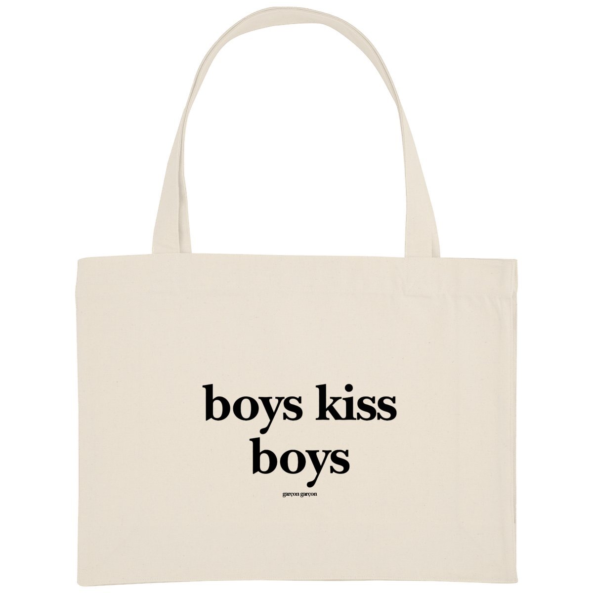 boys kiss boys tote bag. An eco-friendly cream-colored tote bag featuring the bold statement 'boys kiss boys' in black typography, with the brand name 'garçon garçon' subtly placed underneath. A modern accessory that carries more than just your essentials—it carries a message of love and equality.